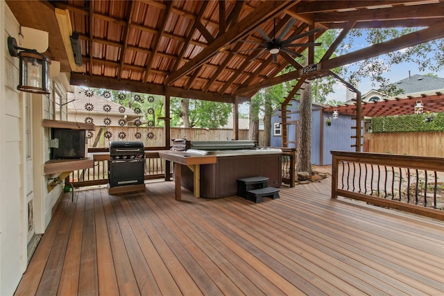 16418 Great Frst, Humble, TX 77346 - wooden deck with a hot tub, grilling area, a fenced backyard, and an outbuilding