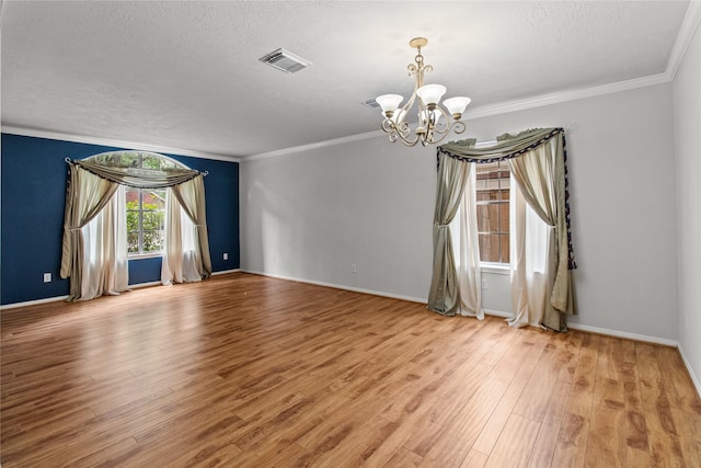 16418 Great Frst, Humble, TX 77346 - empty room with a chandelier, wood finished floors, ornamental molding, and a textured ceiling