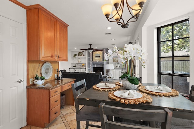 939 Mulberry Ridge Way, Houston, TX 77062 - dining space with ceiling fan, light tile patterned flooring, recessed lighting, a chandelier, and a brick fireplace