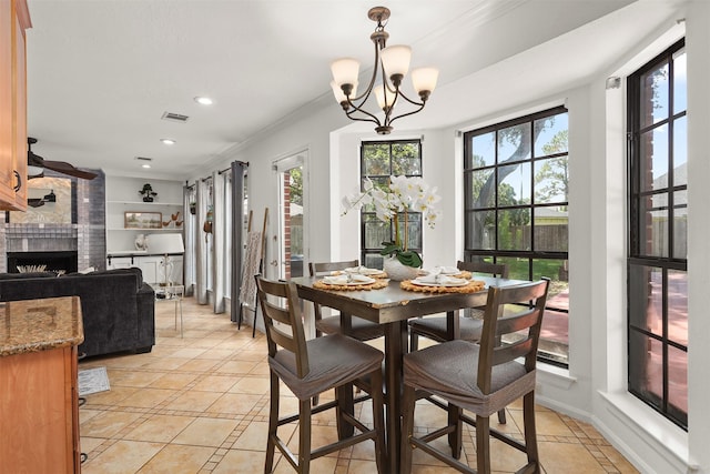 939 Mulberry Ridge Way, Houston, TX 77062 - dining room with light tile patterned floors, a brick fireplace, recessed lighting, a chandelier, and crown molding