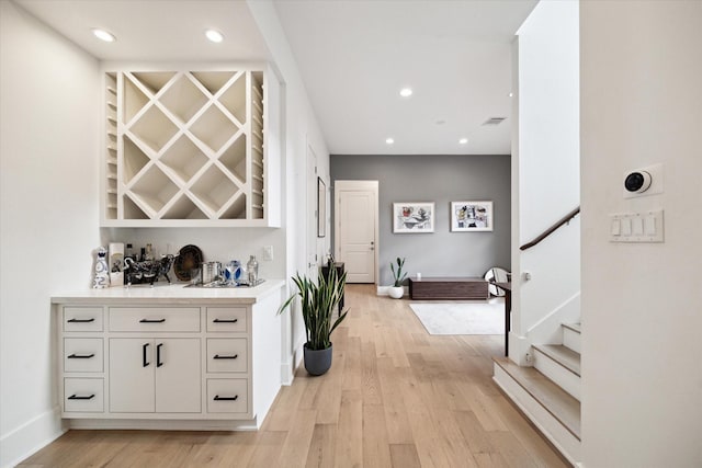 823 Aurora St, Houston, TX 77009 - indoor bar featuring light wood-type flooring, stairs, and recessed lighting
