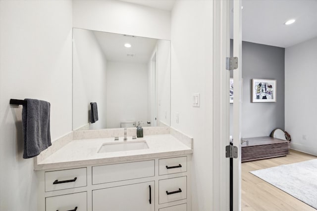 823 Aurora St, Houston, TX 77009 - bathroom with wood finished floors, vanity, recessed lighting, toilet, and baseboards
