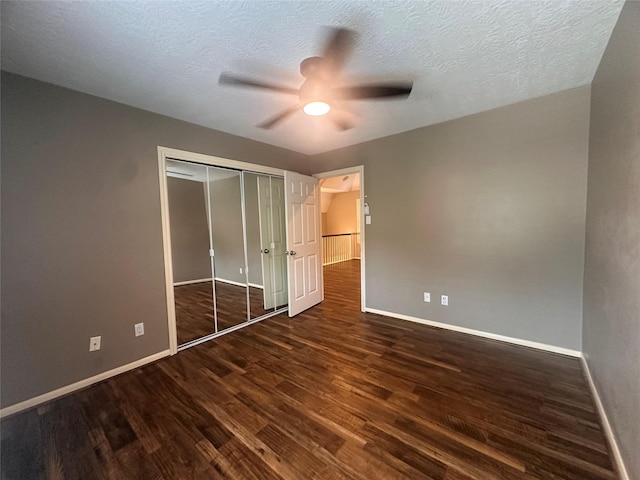 5306 Manor Glen Dr, Kingwood, TX 77345 - unfurnished bedroom with wood finished floors, baseboards, a closet, ceiling fan, and a textured ceiling