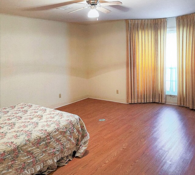 409 W Collier St, Jasper, TX 75951 - bedroom featuring multiple windows, wood finished floors, baseboards, and crown molding