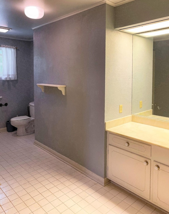 409 W Collier St, Jasper, TX 75951 - bathroom featuring toilet, vanity, ornamental molding, and tile patterned flooring