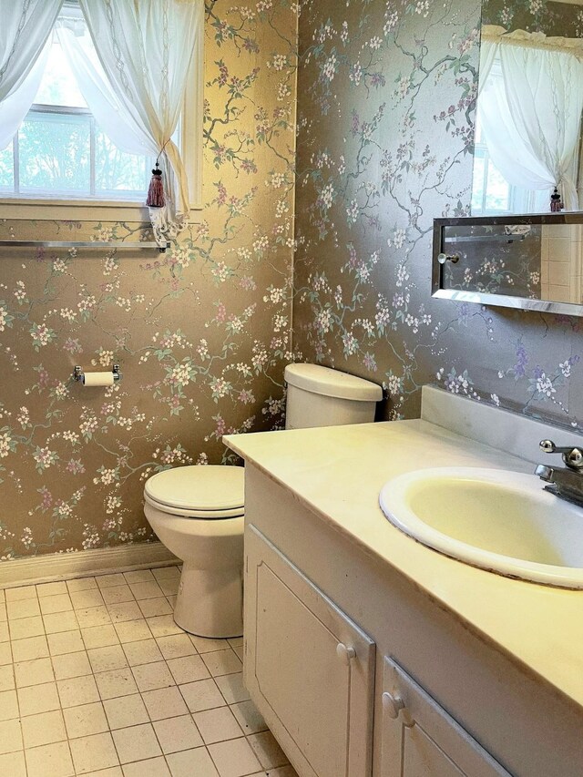 409 W Collier St, Jasper, TX 75951 - bathroom featuring plenty of natural light, toilet, vanity, wallpapered walls, and baseboards