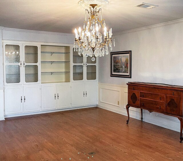 409 W Collier St, Jasper, TX 75951 - unfurnished dining area with a chandelier, crown molding, wood finished floors, and a wainscoted wall