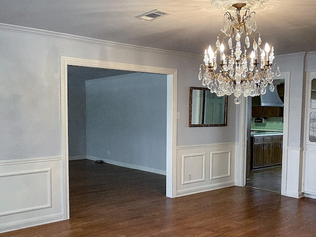 409 W Collier St, Jasper, TX 75951 - unfurnished dining area with wood finished floors, a wainscoted wall, a chandelier, and ornamental molding
