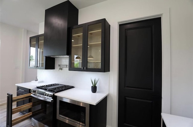 136 E 37th St, Houston, TX 77018 - kitchen with stainless steel appliances, backsplash, light countertops, and dark cabinets
