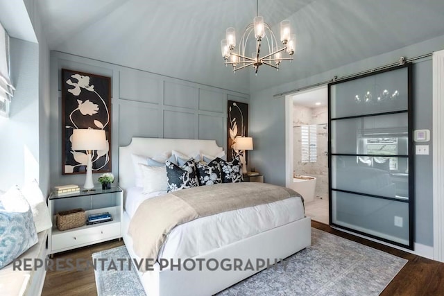 2334 Vargas St, Magnolia, TX 77316 - bedroom with a chandelier, wood finished floors, connected bathroom, and vaulted ceiling