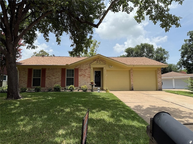 2002 Savanna Ct N, League City, TX 77573 - ranch-style house with concrete driveway, a garage, brick siding, and a front lawn