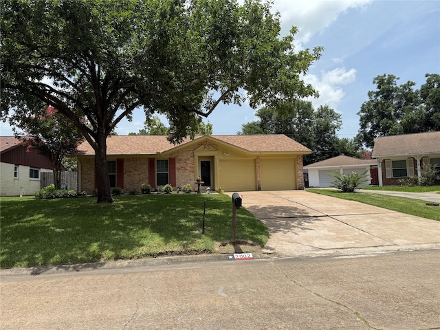 2002 Savanna Ct N, League City, TX 77573 - ranch-style house with a front lawn, concrete driveway, a garage, and brick siding