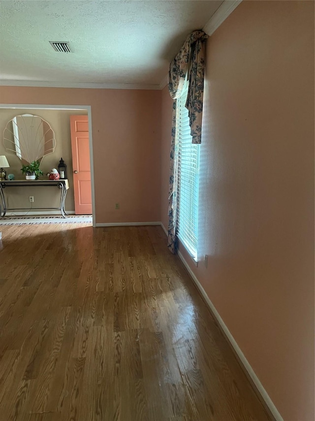 2002 Savanna Ct N, League City, TX 77573 - spare room featuring ornamental molding, wood finished floors, and a textured ceiling