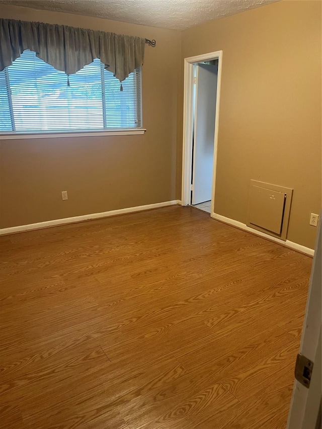 2002 Savanna Ct N, League City, TX 77573 - spare room with wood finished floors and a textured ceiling