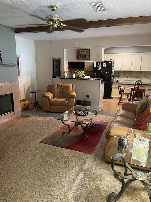 2002 Savanna Ct N, League City, TX 77573 - living area featuring ceiling fan, a textured ceiling, and a tile fireplace