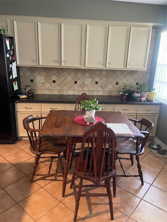 2002 Savanna Ct N, League City, TX 77573 - kitchen featuring freestanding refrigerator, dark countertops, decorative backsplash, and light tile patterned flooring