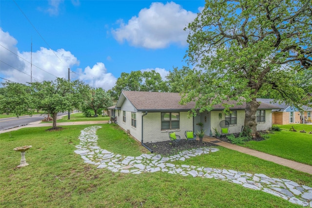 905 Jane Ln, Bryan, TX 77802 - ranch-style house with brick siding, a front lawn, and a shingled roof