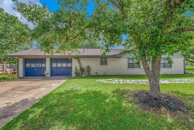 905 Jane Ln, Bryan, TX 77802 - view of front of property featuring an attached garage, brick siding, a front lawn, driveway, and a shingled roof