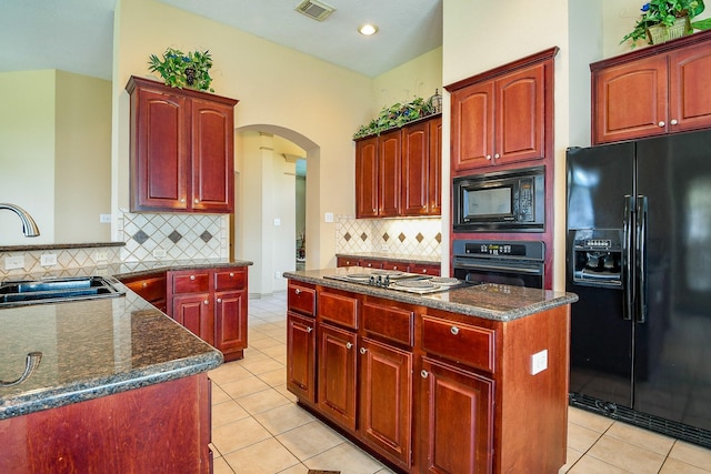 14719 Golden Bough Ln, Humble, TX 77396 - kitchen featuring black appliances, a sink, reddish brown cabinets, arched walkways, and recessed lighting