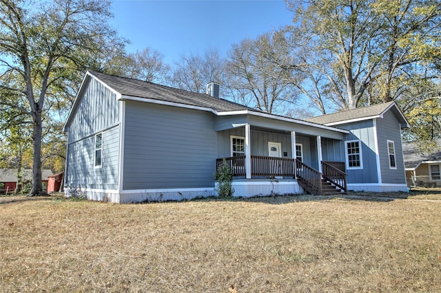 322 Montrose St, Lufkin, TX 75901 - view of front facade featuring a porch, a front yard, and a chimney