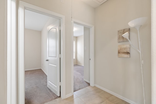 23106 Tindarey Falls Ln, Katy, TX 77493 - hallway featuring baseboards, light colored carpet, and light tile patterned floors
