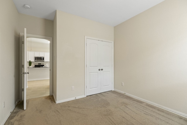 23106 Tindarey Falls Ln, Katy, TX 77493 - unfurnished bedroom with light colored carpet and baseboards