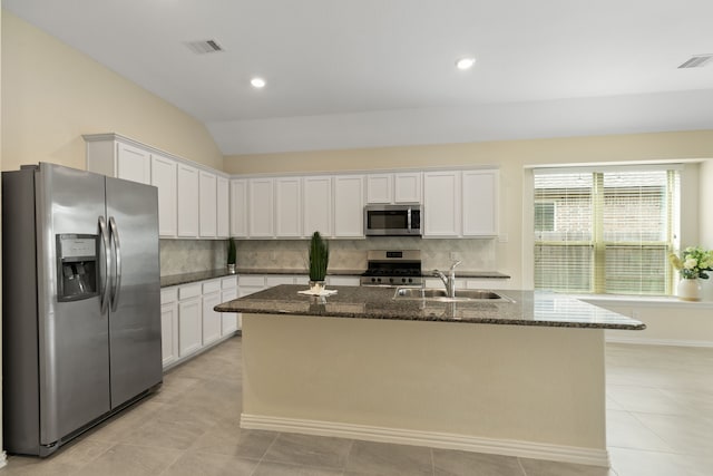 23106 Tindarey Falls Ln, Katy, TX 77493 - kitchen with appliances with stainless steel finishes, a sink, dark stone counters, backsplash, and white cabinetry