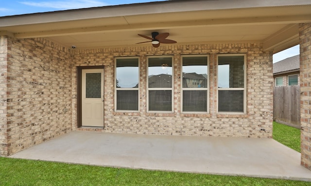 23106 Tindarey Falls Ln, Katy, TX 77493 - view of exterior entry featuring ceiling fan, a patio, and brick siding