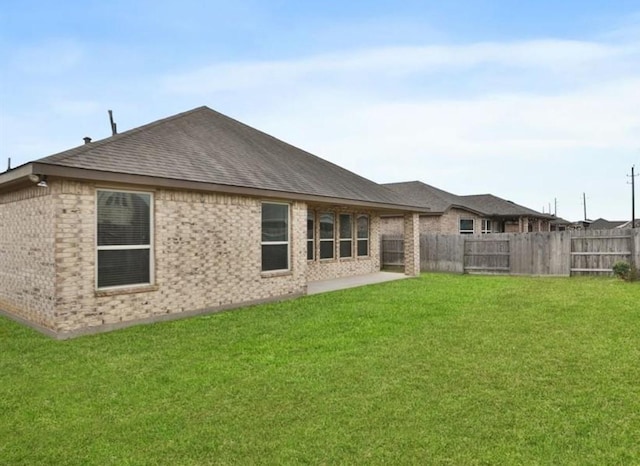 23106 Tindarey Falls Ln, Katy, TX 77493 - back of house with brick siding, roof with shingles, and a patio
