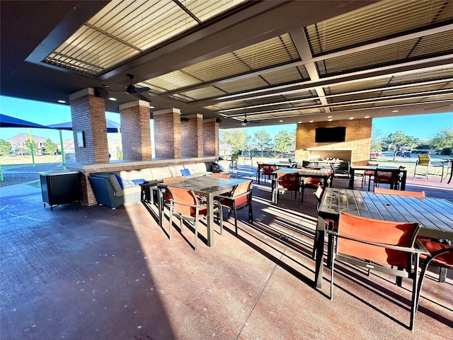 23106 Tindarey Falls Ln, Katy, TX 77493 - view of patio featuring outdoor dining space and a multi sided fireplace