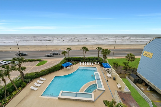 7700 Seawall Blvd Unit 512, Galveston, TX 77551 - view of swimming pool with view of water and beach, a patio area, and a pool with connected hot tub