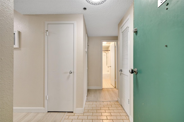 7700 Seawall Blvd Unit 512, Galveston, TX 77551 - hall with a textured ceiling and wood finished floors