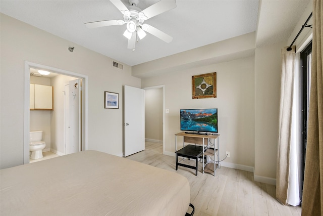 7700 Seawall Blvd Unit 512, Galveston, TX 77551 - bedroom with light wood-type flooring, ensuite bathroom, and a ceiling fan