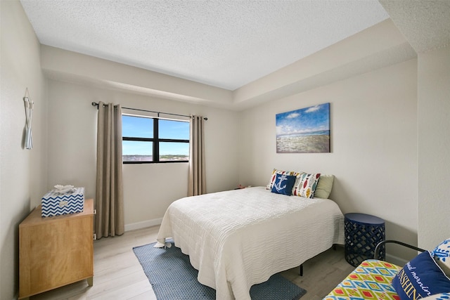 7700 Seawall Blvd Unit 512, Galveston, TX 77551 - bedroom with light wood-type flooring and a textured ceiling