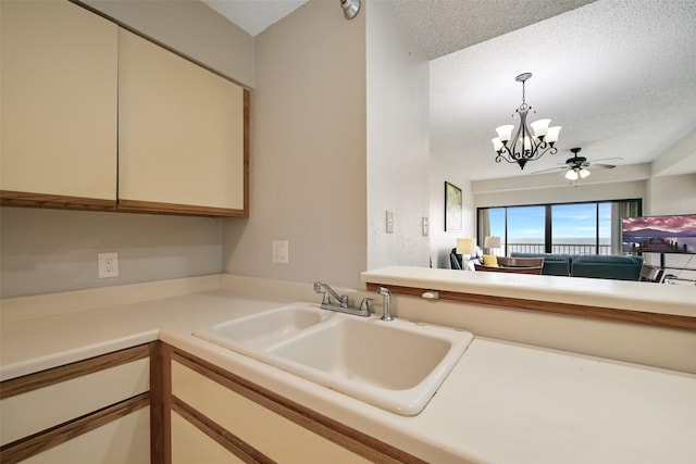 7700 Seawall Blvd Unit 512, Galveston, TX 77551 - kitchen featuring a chandelier, light countertops, pendant lighting, ceiling fan, and open floor plan
