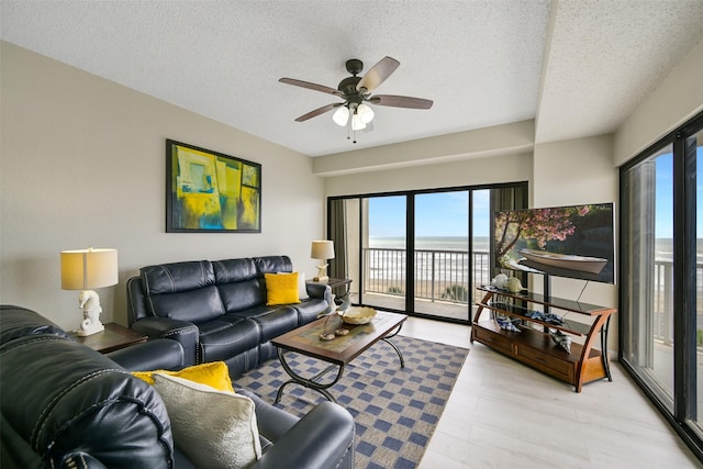 7700 Seawall Blvd Unit 512, Galveston, TX 77551 - living room featuring plenty of natural light, a textured ceiling, ceiling fan, and light wood finished floors