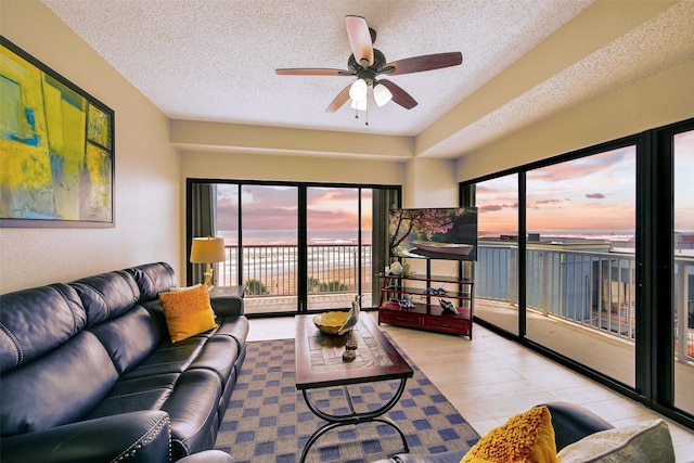 7700 Seawall Blvd Unit 512, Galveston, TX 77551 - living room with healthy amount of natural light, ceiling fan, and a textured ceiling
