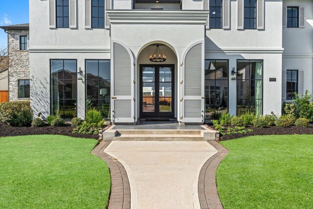 10411 E Rio Grande River Dr, Cypress, TX 77433 - entrance to property with stucco siding, french doors, and a yard