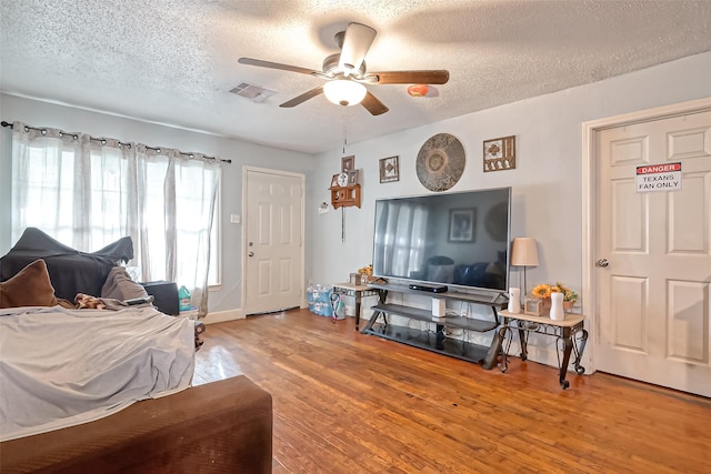 10434 Envoy St, Houston, TX 77016 - living area with ceiling fan, a textured ceiling, and wood finished floors