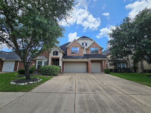 21235 Pennshore Ln, Katy, TX 77450 - view of front of home featuring brick siding, an attached garage, concrete driveway, and a front lawn
