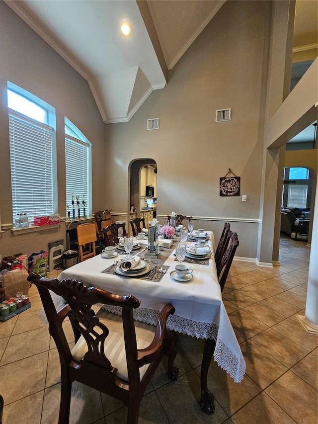 21235 Pennshore Ln, Katy, TX 77450 - dining area with arched walkways, crown molding, tile patterned floors, healthy amount of natural light, and high vaulted ceiling