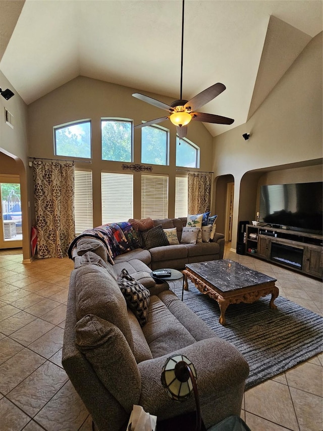 21235 Pennshore Ln, Katy, TX 77450 - living area featuring arched walkways, high vaulted ceiling, light tile patterned floors, and ceiling fan