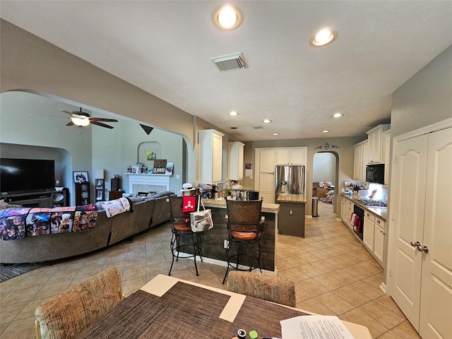 21235 Pennshore Ln, Katy, TX 77450 - dining area featuring arched walkways, light tile patterned floors, a ceiling fan, and recessed lighting