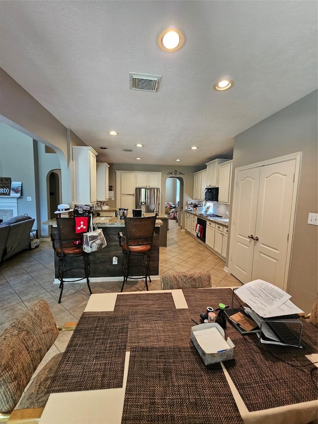 21235 Pennshore Ln, Katy, TX 77450 - dining area with arched walkways, light tile patterned floors, and recessed lighting