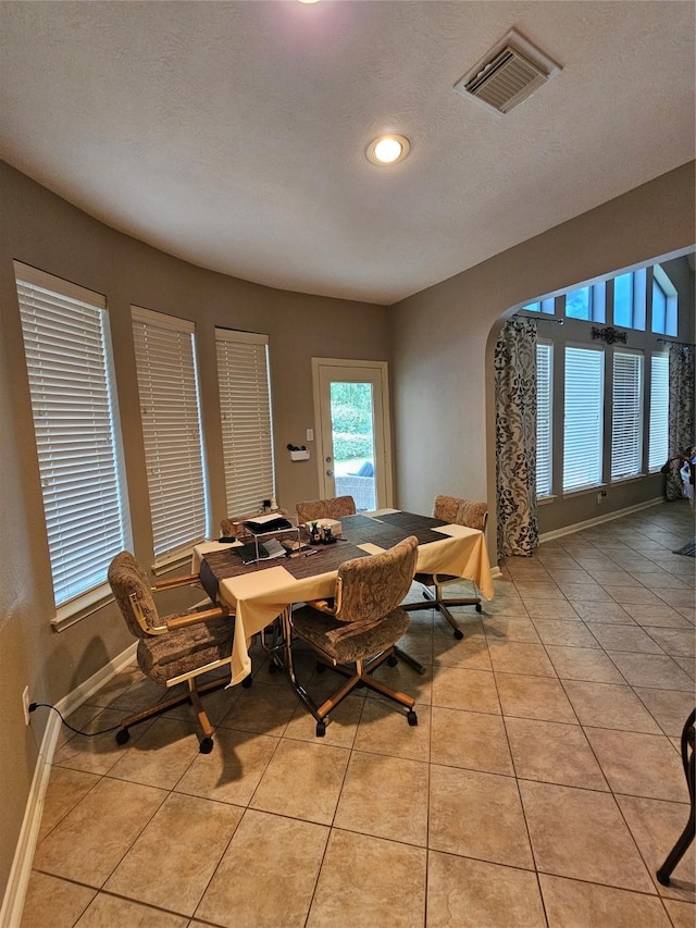 21235 Pennshore Ln, Katy, TX 77450 - dining space featuring arched walkways, light tile patterned floors, baseboards, and recessed lighting