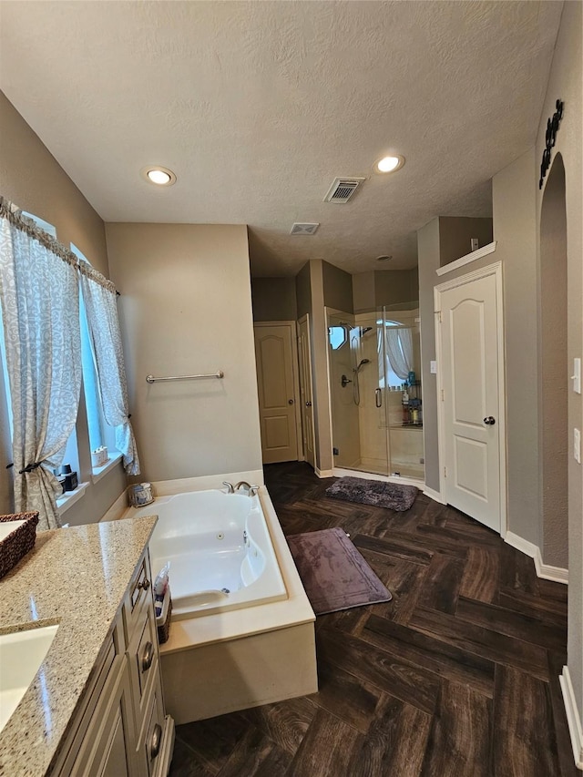 21235 Pennshore Ln, Katy, TX 77450 - full bathroom with a stall shower, a bath, baseboards, a textured ceiling, and vanity