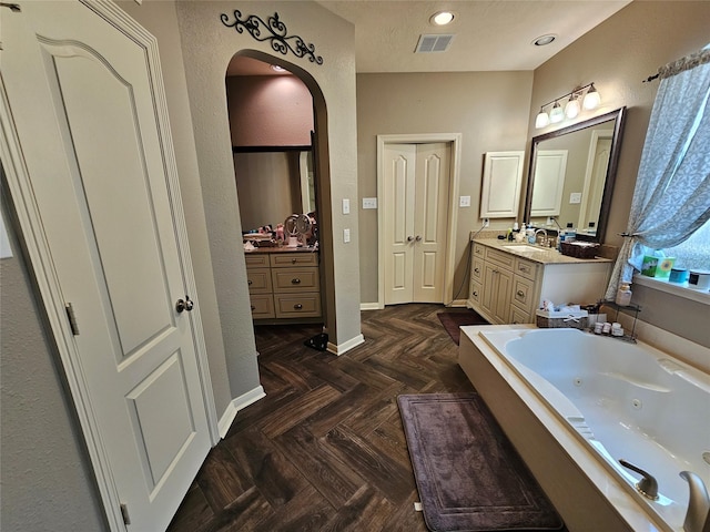 21235 Pennshore Ln, Katy, TX 77450 - bathroom with a jetted tub, vanity, and baseboards