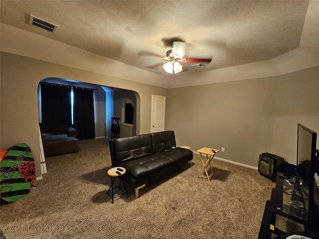 21235 Pennshore Ln, Katy, TX 77450 - home theater room featuring carpet, arched walkways, ceiling fan, baseboards, and a textured ceiling