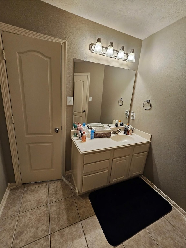 21235 Pennshore Ln, Katy, TX 77450 - bathroom featuring tile patterned flooring, vanity, a textured wall, and baseboards