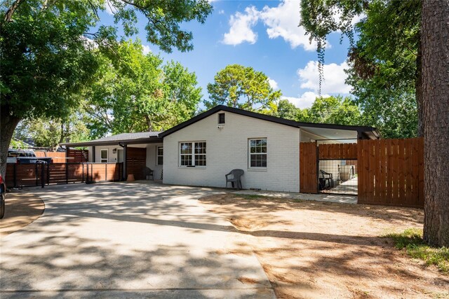 9305 Emnora Ln, Houston, TX 77080 - view of front facade featuring a gate, brick siding, and concrete driveway
